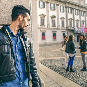 a man watching a group of girls on the street