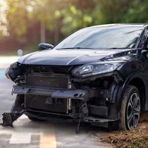 a totaled car off the side of the road