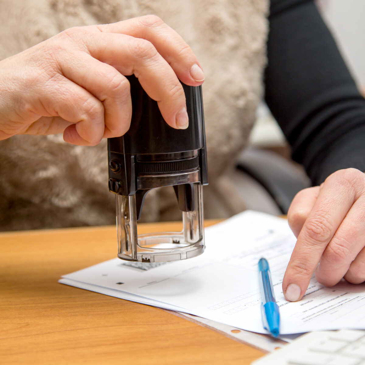 a notary about to stamp a document